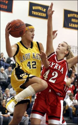 Northview's Niki McCoy eludes Elyria's Kelly Ruth and passes to a teammate. McCoy had 11 points and 6 assists.