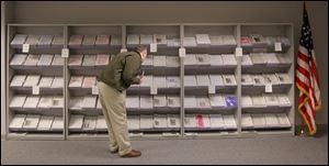 A visitor to the IRS office in 4 SeaGate in downtown Toledo selects from shelves full of taxpayer publications.
