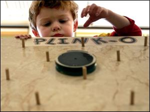 NBR luckey05p 01 - Little Hunter Shiffler, 3, plays plinko at the Luckey Elementary school carnival. The Blade/Allan Detrich