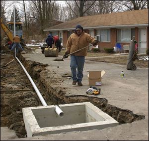 Tim Sanchez and crew work to secure the old well, one of about 500 in Ohio that will be sealed this year.