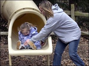 CTY  rove  Oak Openings Metropark.  Zoey Napierala 3, Delta,  is loving  the slides by the nature center.  She didnt mind the chilly weather and she and her mom, Ashley Napierala , make the most of a day off work.  The Blade/Diane Hires  3/17/05
