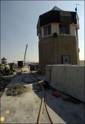 Construction crews work one of the control towers on the Martin Luther King, Jr., Bridge.
