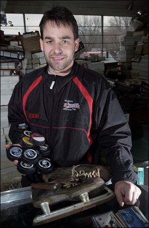 Storm coach Nick Vitucci feels equally at home surrounded by hockey players or hockey memorabilia, including old skates or pucks. He's been collecting trading cards since he was 6 and now has at least 750,000. 