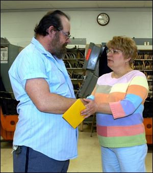 Corrine Martin thanks mail carrier Charles Blasingame at the West Toledo post office for assisting her ailing parents.
