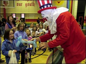NBR fun18p  Indian Hill Elementary School held a fun night at the Rossford, Ohio school on March 18, 2005. Carly (cq) Hollerbach, 7, left, gets a dog made of balloons from Quacky the Clown  at the event. The Blade/Jetta Fraser