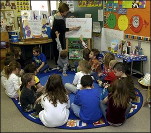 Kindergarten teacher Dianne Fuller has her class in a full circle of attention.