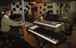 William Menacher has his musical equipment in his basement studio in his home in Springfield Township.
