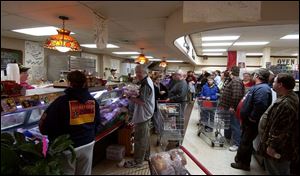 Customers wait in Stanley's Market at 3302 Stickney Ave. to buy some of the 26,000 pounds of kielbasa made for Easter.