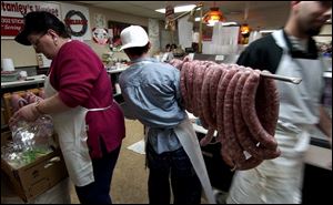 Kevin Chadwick totes a load of rings of kielbasa at Stanley's Market, where the air is heavy with the meat's garlicky scent. 