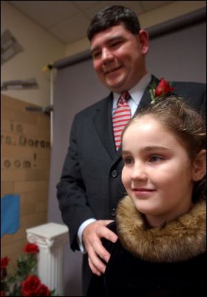 DADDY'S SWEETHEART: Paul Favorite and daughter Taylor find their evening together is their heart's desire at Ladyfield School's Valentines Day dance.