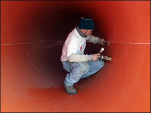 ROV Kalahari29p 2 .jpg   J.R. Pickard, an employee of Whitewater West, works on the inside of a waterslide called Zip coaster that is to be installed at the new Kalahari Resort on route 250 in Sandusky,OH 03/29/2005. The Zip Coaster is the only water slide of its type in the country.