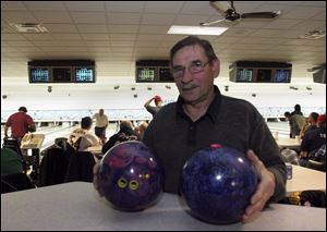 Stan Kruzel of West Toledo says he has several of Storm
Products  scented balls, including the grape-scented one,
right, and an older ball that has nearly lost its scent, left.