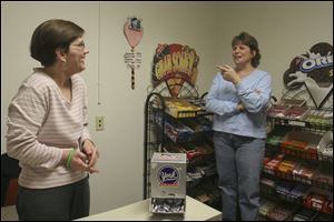 Stella Consevage, left, who operates a snack shop, discusses business with Donna Palazzo, her job coach. Ms. Consevage, who suffered debilitating injuries from a car accident, ignored her doctors who had said she'd never walk or talk again.