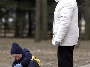 ROV Olander A -- Alex Milochnitchenko, 2,  finds something interesting to look at as his grandmother Elena Milochnitchenko waits patiently. The pair were spending time at Olander Park Monday, 03/21/05. The Blade/Andy Morrison