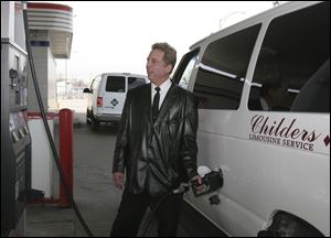 Ben Grossfield fills a Childers Limousine van; the firm says gas for a trip to Metro costs about $32.50.