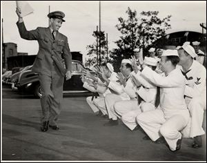 In 1945, Cleveland Indians  pitching great Bob Feller waved
discharge papers at volunteer catchers at Chicago s Navy Pier.
