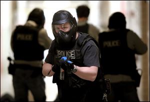 Officers move through the halls of Starr Elementary School during an exercise. The school was closed for spring break.
