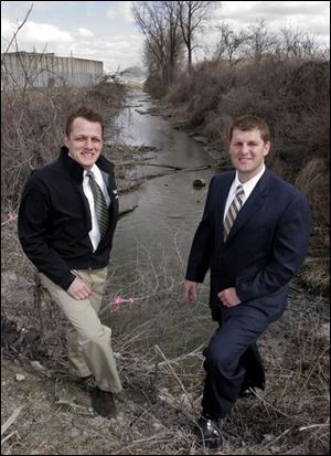 Toledo Councilman Frank Szollosi, left, and his brother, Oregon Councilman Matt Szollosi, discuss Duck Creek, whose rechanneling was the focus of a boundary dispute.
