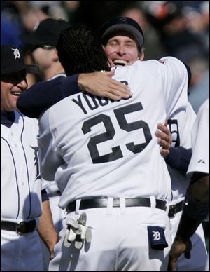 Dmitri Young gets a hug from Tigers manager Alan Trammell after his third home run.
