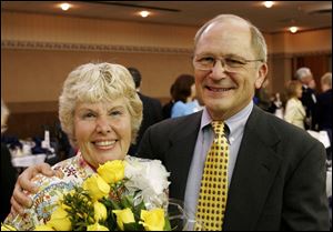 Karen Landis is congratulated by Dave Schlaudecker at a
breakfast on Tuesday at the Zenobia Shrine in her honor.
