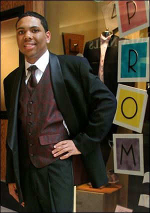Scott High School senior Anthony Walker chose a shawl tuxedo with a vest that coordinates with the color of his date's dress.