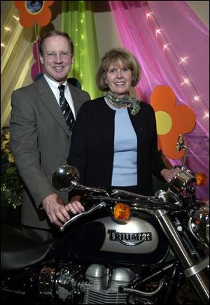 MOTORCYCLE MANIA: Dick and Lynn Baker inspect a motorcycle at the Gladieux event for Toledo Children's Hospital.