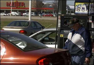 Bud Madden fills up in Sylvania Township. Meijer is one of four chains locally that sell gasoline.