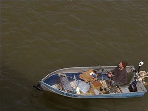 ROV boating for walleye Kettering, OH resident Harold Myers casts for walleye from his boat in the Maumee River in between Perrysburg and Maumee Tuesday, March 22, 2005. The Blade/Lori King