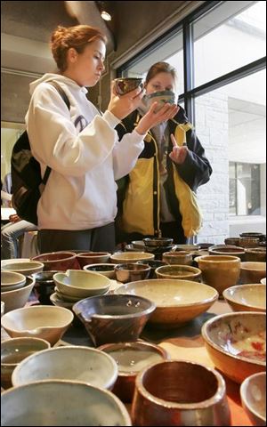 ROV  Catie (cq) Antoline, 22, left, and Amanda Cochran, 22, right, decide which bowls to buy during a 