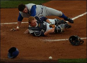 Hens catcher Chris Shelton loses the ball after a collision with Durham's Jonny Gomes.
