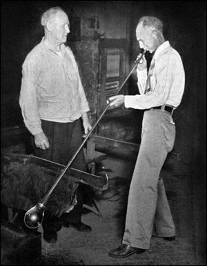 Ernie Pyle, visiting Toledo in August of 1941, tries his hand at blowing glass under the guidance of Libbey master craftsman Aaron Bloom. The columnist died 60 years ago today.