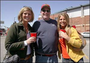 PARTY TIME: Britt Lock, left, Bob Douglas, and Mindy Hudson find that the parking lot is an excellent place for a party.