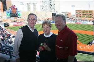 CENTER FIELD: Joe Boyle, left, and his wife, Eileen, visit with Jim Murray during opening day at Fifth Third Field in the Toledo Edison suite.
