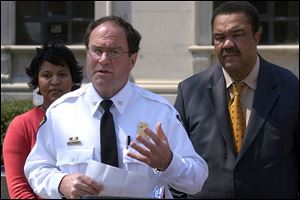 Flanked by Councilman Karyn McConnell-Hancock and Mayor Jack Ford, Chief Michael Navarre
says that paying to extradite more suspects may be costly but is  the right thing to do. 

