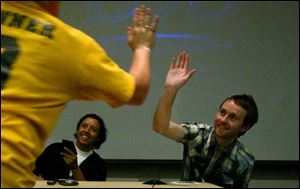 'Napoleon Dynamite' cast member Efren Ramirez, left, looks on as fellow actor Aaron Ruell high-fives a fan at BGSU.