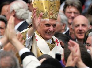 Pope Benedict XVI greets the faithful from the Popemobile after the Ceremony of Investiture.
