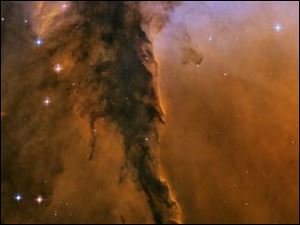 Scientists used the newer ACS camera to revisit one region of the eerie-looking Eagle Nebula, producing a new image with stunning detail. The image reveals a tall, dense tower of gas being sculpted by ultraviolet light from a group of massive, hot stars. The Eagle Nebula image was taken in November 2004.