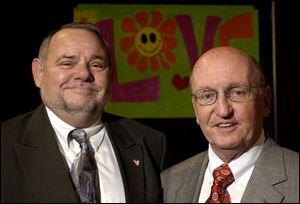 ALL YOU NEED IS LOVE: Bob McCloskey and Andy Kandik smile after receiving honors from the East Toledo Family Center.
