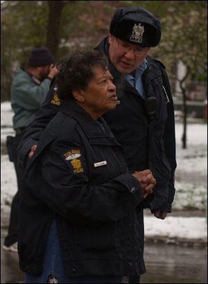Officer Eugene Kutz talks with Florence Cheeves. Officer Kutz and patrol partner Rodney Clark helped Mrs. Cheeves and her husband flee the fire.