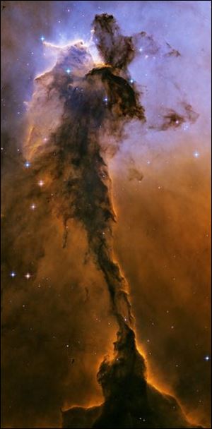 Scientists used the newer ACS camera to revisit one region of the eerie-looking Eagle Nebula, producing a new image with stunning detail. The image reveals a tall, dense tower of gas being sculpted by ultraviolet light from a group of massive, hot stars. The Eagle Nebula image was taken in November 2004.