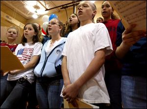 NBR camp23p    Brandy DePew, far right, in white shirt sing along with the rest of the choir from East Toledo Junior High, singing in the gym Saturday morning 4/23/05 .  Outside activites of the Civil War were rather damp due to the rain.  The Blade/Madalyn RUggiero