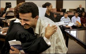 New citizen Munther Gammoh celebrates with a spontaneous hug of U.S. Magistrate Vernelis Armstrong. 