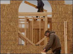 BIZ build01p 1 Lett Construction framers Russ Lett, owner, on ground, and Denny Moore frame one of Crystal Ridge Villas off Monclova Rd., April 27, 2005. The Blade/Lori King