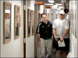 It's a tight fit for football coach Gregg Brandon and Scott Mruczkowski, recently drafted by the San Diego Chargers, in the current hallway for Bowling Green athletic offices at Perry Stadium. 