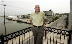 Dan Delahunt on a balcony at his downtown building, where six of the nine condos are to feature a view of Lake Erie. 