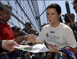 Danica Patrick signs autographs for fans at Indianapolis Motor Speedway. She started racing Go Karts at age 10. 