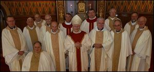 Toledo Catholic Diocese priests with 40 years or more in the priesthood include, from left, the Rev. Robert Weithman, the Rev. Roger Bonifas, the Rev. Joseph O Brien (seated), the Rev. Richard Dunn, the Rev. Benedict Ringholz, the Rev. Michael Ricker, the Rev. Stephen Stanbery, Bishop Leonard Blair, the Rev. Dennis Hartigan, the Rev. Paul Kwiatkowski, the Rev. Nick Weibl, the Rev. Thomas Leyland, the Rev. Frederick Duschl, and the Rev. Martin Donnelly.
