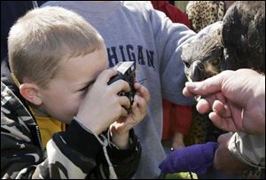 
Gabe Burton, 8, takes a close-up of the eaglet.
