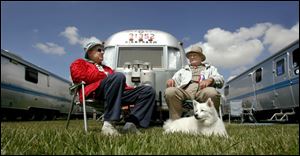 Blue skies and a lush carpet of grass help Raymond Mills, left, and Ken Hunter, with canine pal
Candy, enjoy the regional rally of Airstream owners at the Sandusky County Fairgrounds.