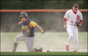 Archbold's Brooks Wagler celebrates after sliding safely into second base under the tag by Patrick Henry's Ben Botjer.